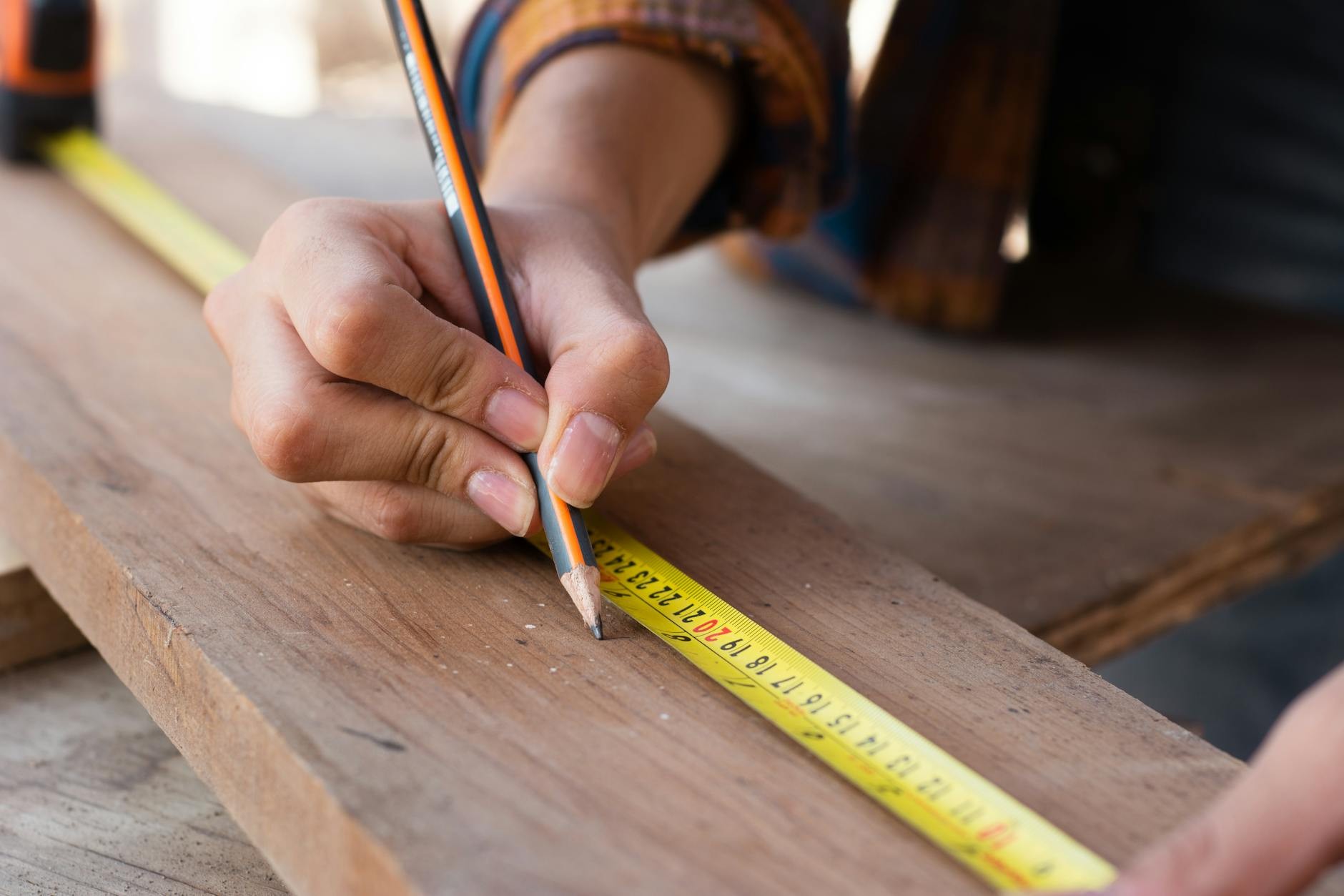 Craftsperson cutting timber by hand